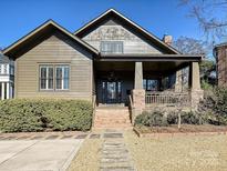Charming two-story home with a landscaped yard, brick steps and inviting front porch at 813 Brookside Ave, Charlotte, NC 28203