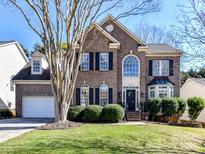 Charming two-story brick home featuring a well-manicured lawn and tasteful landscaping at 9906 Mitchell Glen Dr, Charlotte, NC 28277