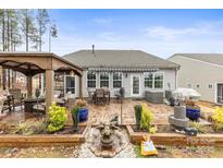 Serene backyard featuring a patio area, gazebo, and garden beds at 1029 Dali Blvd, Mount Holly, NC 28120