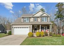 Charming two-story home with attached two-car garage, landscaped front yard, and covered front porch at 1196 Hummingbird Ln, Rock Hill, SC 29732