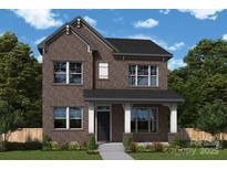 Charming two-story brick home with a covered front porch and well-manicured lawn at 17021 Malone Ln, Mint Hill, NC 28227