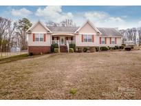 Charming single-Gathering home featuring red shutters and a spacious front yard, perfect for outdoor activities at 292 Miller Farm Rd, Statesville, NC 28625