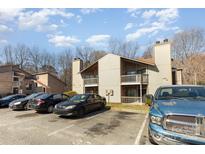 Inviting townhouse featuring a private balcony, neutral tones, and convenient parking in a well-maintained community at 4400 Sharon Chase Dr, Charlotte, NC 28215