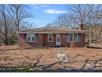 Charming brick home featuring symmetrical window placement and a well-maintained front yard at 1874 Mcilwain Rd, Lancaster, SC 29720