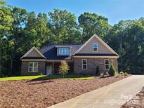 Charming brick home featuring manicured landscaping and a classic architectural design at 404 Imperial Way, Albemarle, NC 28001