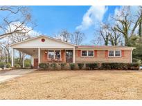 Charming brick home with a cozy front porch and a convenient carport at 509 Sumter St, Lancaster, SC 29720