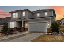 Two story home featuring a two car garage and neutral toned siding and brick accents at 531 Red Wolf Ln, Clover, SC 29710