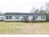 Charming home featuring a deck, complemented by a spacious yard and accented with green shutters at 1766 Duckwood Rd, Lancaster, SC 29720