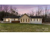 Charming single-story home featuring neutral siding, brick accents, and decorative shutters at 201 Indian Hill Rd, Union Grove, NC 28689