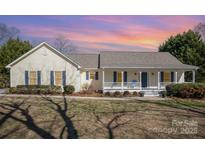 Charming home with a welcoming front porch, beautiful yard, and classic architectural details at 202 Oakwood St, Stanfield, NC 28163
