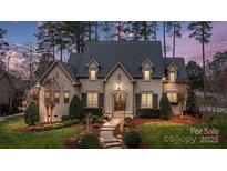 Charming home exterior featuring manicured landscaping, and elegant architectural details at 2114 Garden View Ln, Weddington, NC 28104