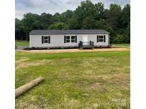 Charming single-story home featuring a well-manicured lawn and inviting front porch at 514 Eagle Mills Rd # 3, Hamptonville, NC 27020
