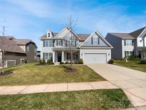 Charming two-story home with a manicured lawn and attached two-car garage at 6234 Artigas Dr, Fort Mill, SC 29707