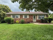 Charming one-story brick home with a well-maintained lawn and minimal landscaping at 948 Shannon Bradley Rd, Gastonia, NC 28052