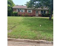 Charming brick home with a well-manicured front lawn and mature trees, offering great curb appeal at 948 Shannon Bradley Rd, Gastonia, NC 28052