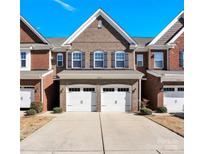 Charming brick townhome with two-car garage and well-manicured landscaping at 105 Clarendon St # C, Mooresville, NC 28117