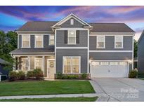 Charming two-story home featuring a manicured lawn and a two-car garage, perfect for Gathering living at 1082 Dorsey Dr, Fort Mill, SC 29715
