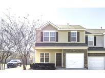 Charming two-story townhome features a one car garage, stone accents, and tasteful curb appeal at 11029 Ardglass Ct, Charlotte, NC 28213