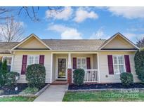 Charming single-story home featuring manicured landscaping and a welcoming front porch at 1362 Copper Creek Ln, Fort Mill, SC 29715
