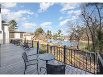 Enjoy scenic lake views from the outdoor deck with seating, perfect for relaxation and entertaining guests at 20105 Chapel Point Ln, Cornelius, NC 28031