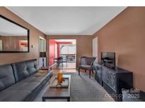 Comfortable living room with a view of the outdoor dining area at 2607 Vail Ave, Charlotte, NC 28207