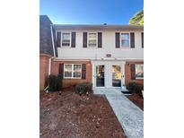 Traditional two-story townhome with red brick and symmetrical facade at 5810 Hunting Ridge Ln # C, Charlotte, NC 28212