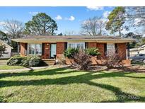 Charming brick home with a well-maintained front yard and inviting walkway at 5908 Brookhaven Rd, Charlotte, NC 28210