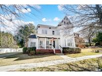 Charming two-story home with white exterior, inviting front porch, and well-manicured landscaping at 815 Stratford Run Dr, Fort Mill, SC 29708