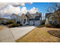 Charming two-story home features a spacious driveway and attached two-car garage at 827 Bluff Loop Rd, Rock Hill, SC 29730