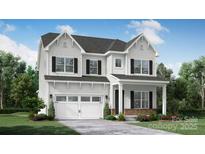 Two-story home boasts charming architectural details, including shingle accents and an attached two-car garage at 000 Millstream Rd # 149, Denver, NC 28037