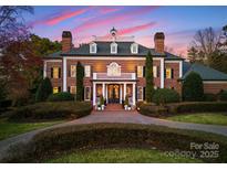 Stately brick home featuring manicured landscaping and a circular driveway at 131 The Point Dr, Mooresville, NC 28117