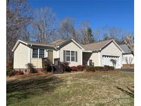 Charming single-story home with a well-manicured lawn, attached garage, and inviting front porch at 1420 28Th Sw St, Hickory, NC 28602