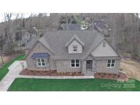 Charming brick home featuring a manicured lawn, stylish dormer, and inviting entryway at 2069 Landry Ln # 233, Rock Hill, SC 29732