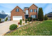 Charming two-story brick home with a well-manicured lawn and attached two-car garage at 2622 Rolling Ridge Dr, Hickory, NC 28602