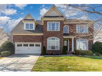 Charming brick two-story home featuring a well-manicured lawn and an attached two-car garage at 3046 Denali Way, Rock Hill, SC 29732