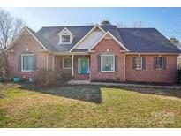 Charming brick home featuring a well-manicured lawn and a bright blue front door at 912 Silver Charm Ln, York, SC 29745