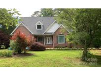Charming brick home with a well-manicured lawn and lush landscaping, offering great curb appeal at 912 Silver Charm Ln, York, SC 29745