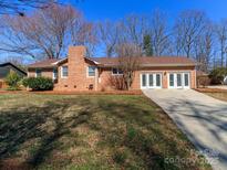 Charming one-story brick home featuring an attached garage and mature trees at 1003 Oak Hill Dr # 24, Monroe, NC 28112