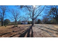 Charming home featuring a spacious front yard with mature trees and a sunny exposure at 1116 Medlin Rd, Monroe, NC 28112