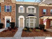 Charming townhome with a landscaped front yard and a mix of brick and siding facade at 13811 Waverton Ln, Huntersville, NC 28078