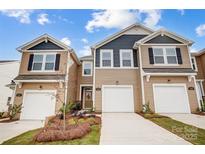 Charming townhome featuring a well-maintained lawn, attached garages, and classic design at 2320 Hedgecliff Rd # 158, Kannapolis, NC 28025