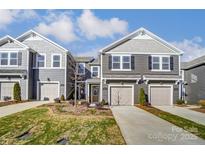 Charming townhome featuring a one-car garage, beautiful landscaping, and a well-maintained lawn at 2330 Hedgecliff Rd # 157, Kannapolis, NC 28025