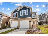 Charming two-story townhome with attached garages, landscaped front yard, and inviting entryway at 2350 Hedgecliff Rd, Kannapolis, NC 28025