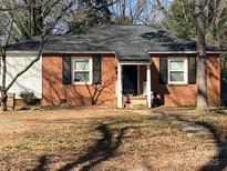 Charming single-story brick home with black shutters and a well-maintained front yard at 2518 Lumina Ave, Charlotte, NC 28208