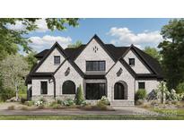 Beautiful exterior elevation featuring white painted brick, black trim, and landscaped yard at 310 Sugar Maple Ln, Weddington, NC 28104