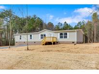 Charming single-story home with a welcoming front porch and a well-maintained lawn and wooded backdrop at 3357 34Th Avenue Ne Ct, Hickory, NC 28601