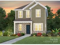 Charming two-story home featuring stone accents, manicured landscaping, and a welcoming front porch at 3616 Pamlico St # 125, Monroe, NC 28110