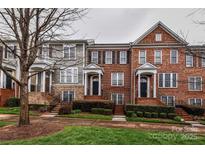 Beautiful townhomes feature brick facades, manicured landscaping, and inviting entryways at 599 Sixth Baxter Xing, Fort Mill, SC 29708