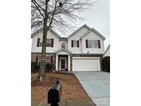 Charming two-story home boasts a stone accent and a large, attached two-car garage at 8833 Goldfields Dr, Charlotte, NC 28227