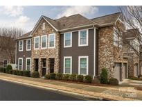 Charming multi-level townhome with stone accents and well-maintained landscaping at 1019 Archibald Ave, Fort Mill, SC 29708